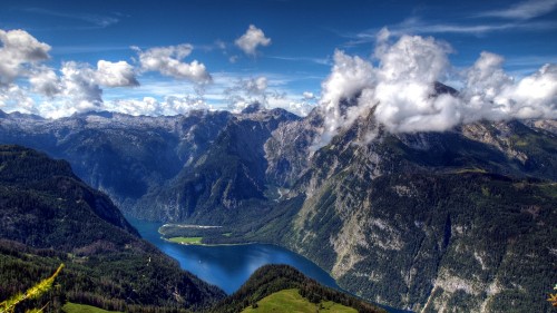 Image green and black mountains under blue sky and white clouds during daytime