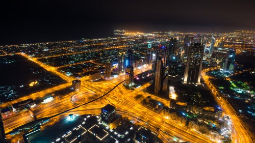 Image city with high rise buildings during night time