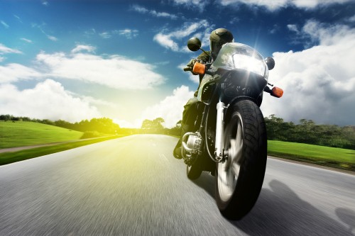 Image man in black helmet riding on green motorcycle on road during daytime