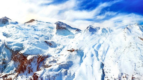 Image snow covered mountain under cloudy sky during daytime