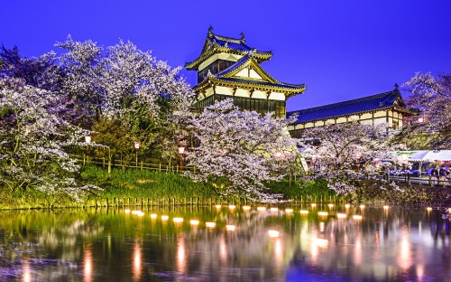 Image white and black temple near body of water during daytime