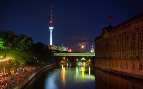 Image brown concrete building near body of water during night time