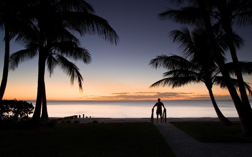 Image silhouette of people walking on beach during sunset