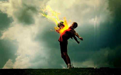 Image woman in red t-shirt and black shorts holding yellow fire