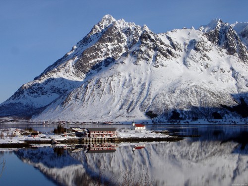 Image white and brown house near snow covered mountain during daytime