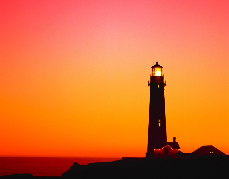 silhouette of lighthouse during sunset