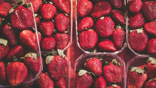 Image red strawberries in clear plastic container