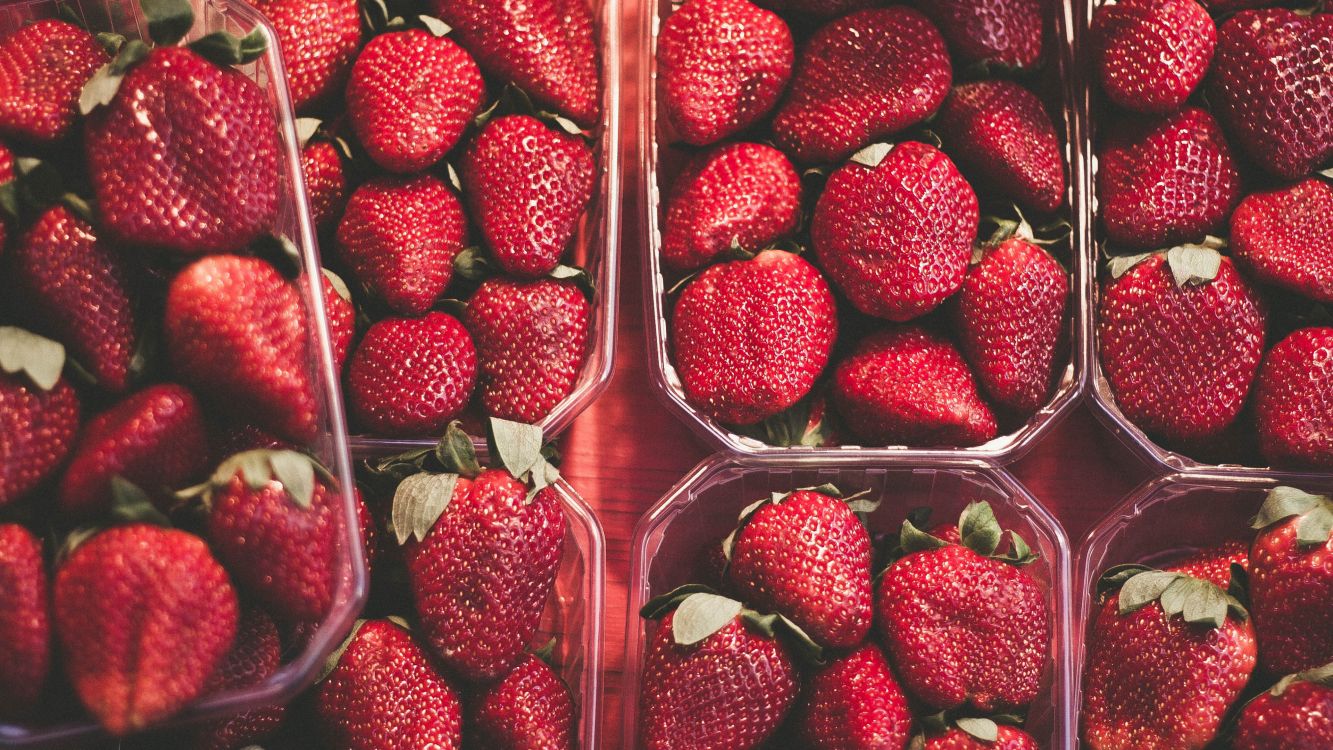 red strawberries in clear plastic container