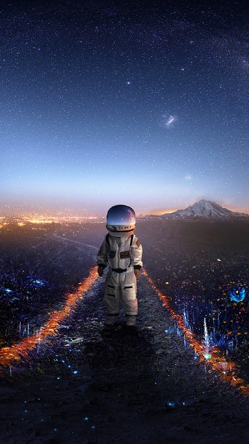 Image man in black jacket and gray knit cap standing on top of mountain looking at the with with with with