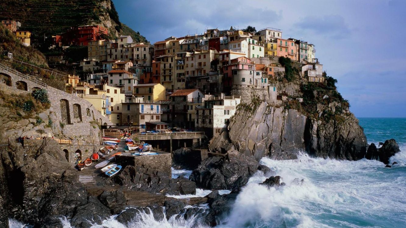 brown and white concrete buildings near body of water during daytime