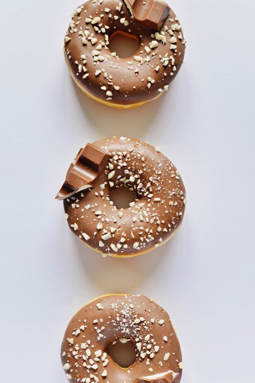 Brown Donut on White Table. Wallpaper in 3680x5520 Resolution