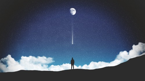 Image silhouette of person standing on top of mountain under blue sky with full moon