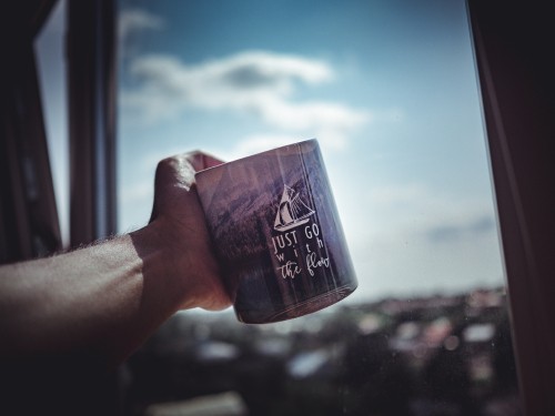 Image person holding black and white ceramic mug