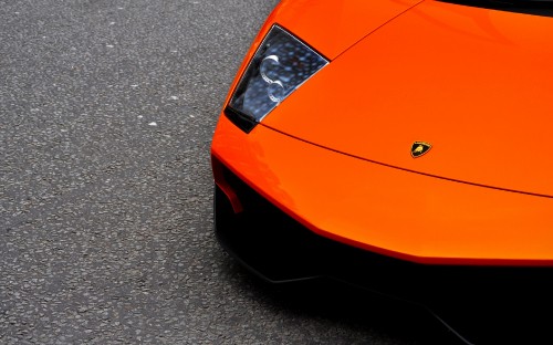 Image orange ferrari car on road