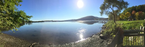 Image body of water near mountain under blue sky during daytime