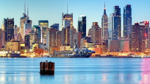 Image city skyline across body of water during daytime