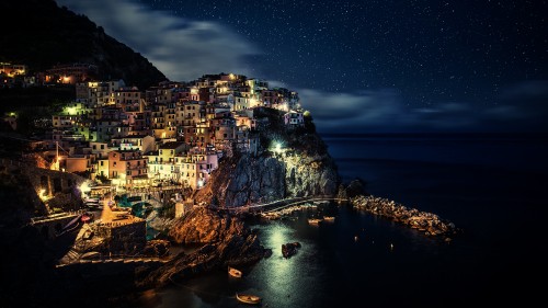 Image city buildings near body of water during night time