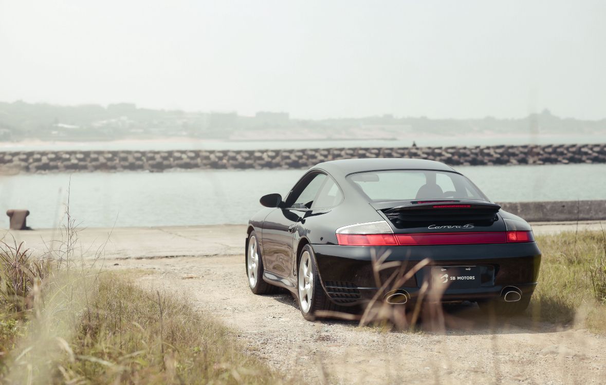 black bmw m 3 coupe on seashore during daytime