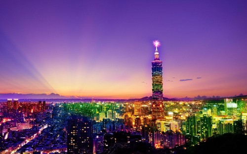 Image city with high rise buildings during night time