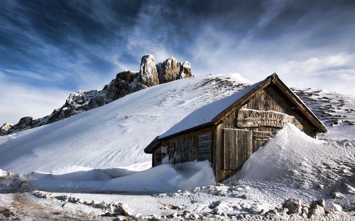 brown wooden house on snow covered ground