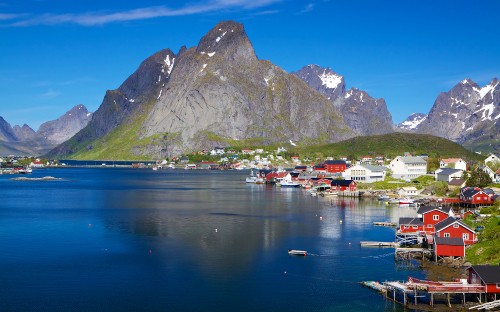 Image white and brown boat on body of water near mountain during daytime