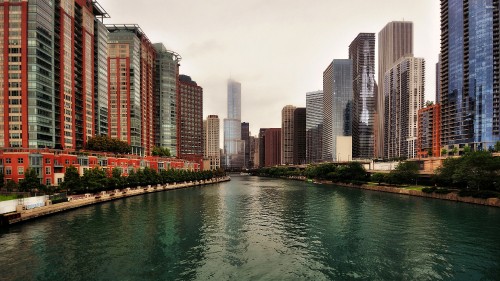 Image body of water between high rise buildings during daytime