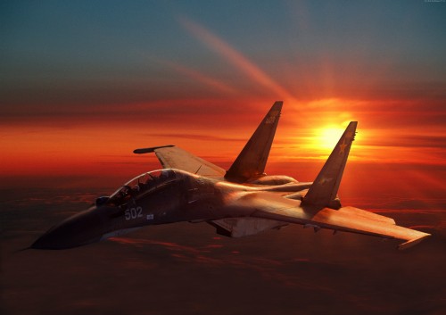 Image white and black jet plane in mid air during sunset