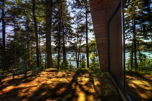 Image brown wooden house near green trees during daytime