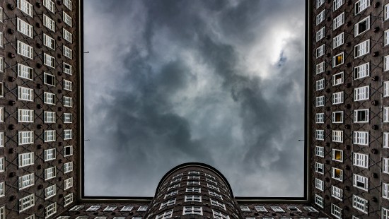 Image brown brick building under white clouds and blue sky during daytime