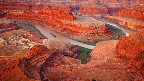 Image aerial view of brown and green mountains and body of water